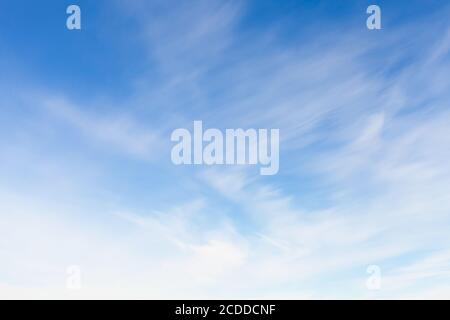 Blue sky with blurred windy clouds at daytime. Natural background photo texture Stock Photo
