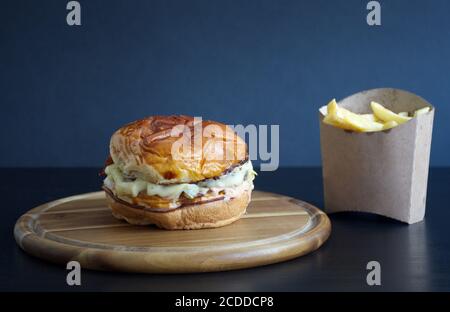 Beef burger and french fries on black wooden table Stock Photo