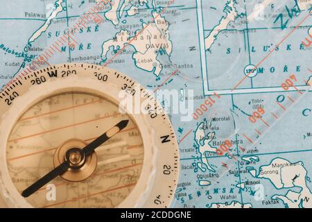 old transparent plastic sport compass with azimuth measurement on old map background Stock Photo