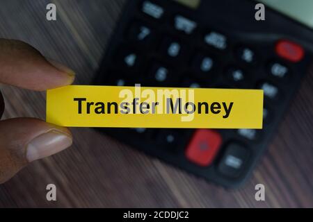 Transfer Money write on sticky notes isolated on office desk. Stock Photo