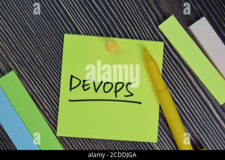 Devops write on sticky notes isolated on office desk. Stock Photo