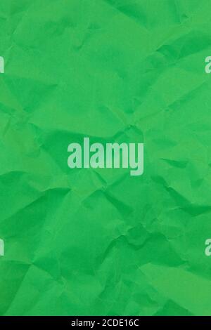 Textured crumpled green paper background. Vertical Stock Photo