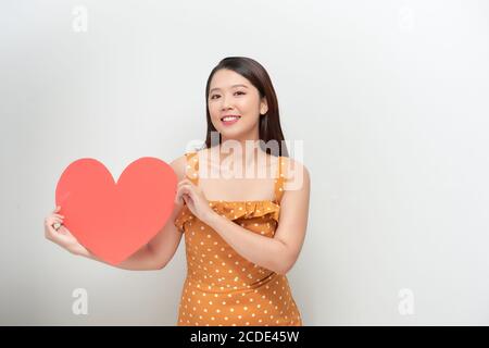 Woman holding big red heart on white background Stock Photo