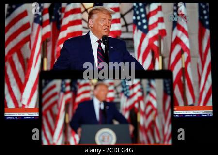 Washington, USA. 28th Aug, 2020. Photo taken in Arlington, Virginia, the United States, on Aug. 27, 2020 shows screens displaying U.S. President Donald Trump delivering his acceptance speech during the 2020 Republican National Convention. Trump accepted the Republican Party's nomination for reelection in a speech from the White House South Lawn on Thursday night. Credit: Liu Jie/Xinhua/Alamy Live News Stock Photo