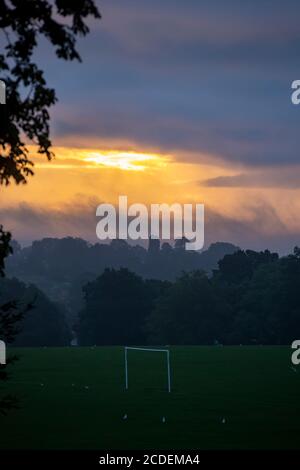 Northampton, UK, Weather. 28th August 2020. Dawn sky breaking through the clouds over Abington Park  this morning with another wet day forecast for Northampton. Credit: Keith J Smith./Alamy Live News Stock Photo