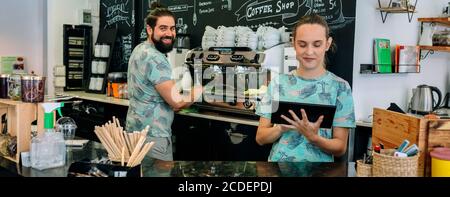 Smiling coffee shop workers posing Stock Photo