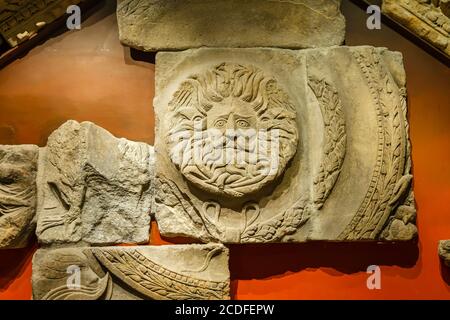 The carved Bladud Gorgon Head from the temple pediment on display in the museum at the Roman Baths in Bath, Somerset, south-west England Stock Photo