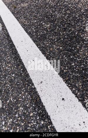 Old asphalt road with separation line. Selective focus. Stock Photo
