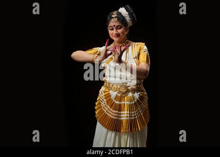 Mohiniattam dancer performing dance depicting bee drinking nectar from a flower Stock Photo