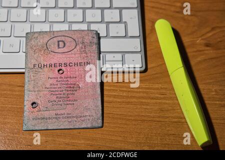 PLON, GERMANY - Aug 25, 2020: Plon, Germany, August 25 2020, old used, dirty pink German driving license Stock Photo