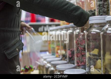 Selective focus shot of various candies in glass containers displayed at a candy shop Stock Photo