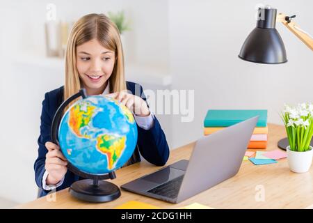 Portrait of her she nice attractive intellectual brainy cheerful small little long-haired girl using laptop learning world political map researching Stock Photo