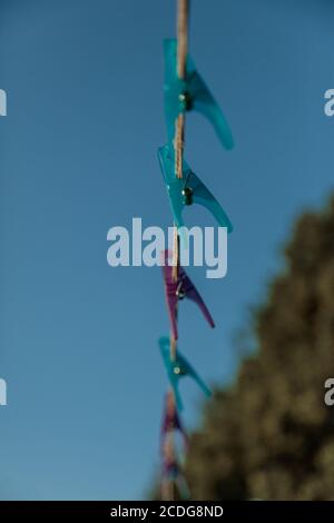Clothespins on a clothesline against the sky, selective autofocus. High quality photo Stock Photo