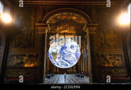 London, UK. 28th Aug, 2020. Luke Jerram's spectacular artwork 'Gaia' is being displayed in the Painted Hall as part of the 2020 Greenwich Docklands International Festival from 28th August - 6th September. Gaia aims to inspire awe and the 'Overview Effect' for the Planet Earth. The immense 7 metre sculpture is an internally-lit exact replica of the planet using NASA imagery, displayed to music by Dan Jones. Credit: Tommy London/Alamy Live News