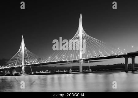 Night view of traffic on cable stayed bridge across Petrovsky fairway in Saint-Petersburg, Russia Stock Photo