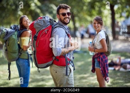 Group of smiling  friends backpackers walking and traveling  and enjoying  together. Stock Photo