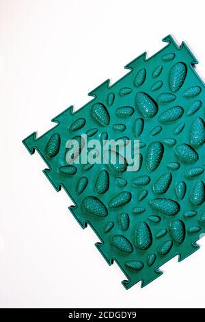 A green orthopedic mat with the design of cones to prevent flat feet Stock Photo