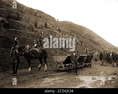 Workmen building  the Whitby to Sandsend  village coastal Road (North Yorkshire, UK)  May 9th 1923. The whole project involved physically digging out the bank-side by hand  using labourers. Prior to the road opening, the  only direct  route was along the beach at low tide. The man in the trilby hat (front) is believed to be Mr. Alfred Porritt of High Street, Ruswarp. The man at the rear in plus fours is believed to be the Marquis of Normanby with his wife  the marchioness, inspecting the works Stock Photo