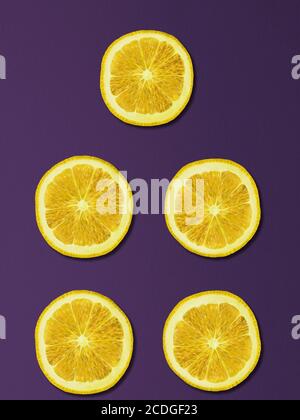 Lemon slices on the table. Top view. Purple background Stock Photo