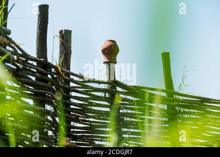 Fence wicker from the vine, texture, background. Wicker vine fence. woven vines texture embossed background. Organic woven willow wicker fence panel s Stock Photo