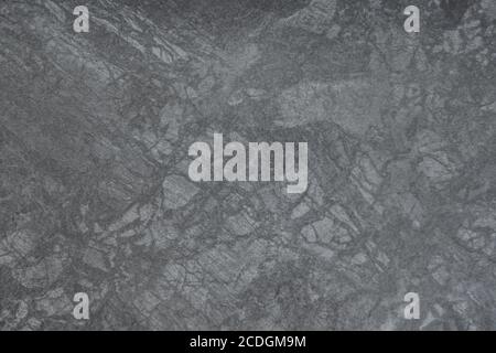 The texture of a ceramic tile - a close-up of a dark gray matt ceramic tile Stock Photo