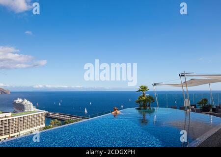Portugal, Madeira, Funchal, View from the New Royal Savoy Hotel rooftop infinity pool looking towards the Pestana Casino Hotel and cruise ship termina Stock Photo