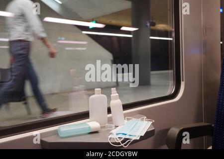 Interior commuter train in Switzerland with face mask and disinfectants as measure for fighting against coronavirus and covid-19. Stock Photo