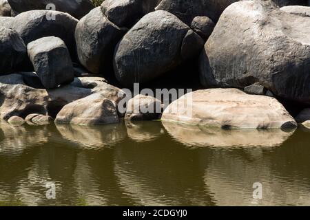 rock pattern and reflection at tungabhadra Stock Photo