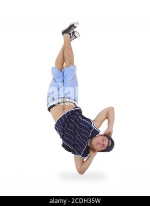 young male dancer performing a bboying stunt Stock Photo