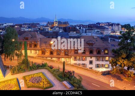 Skyline of Lausanne, Switzerland as seen from the Cathedral hill from twilight. The focal point of the skyline is the tower of St-Francois Church, whi Stock Photo