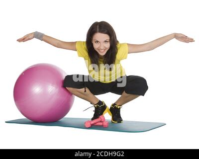 Attractive young female with fitness dumbbells in sport center Stock Photo