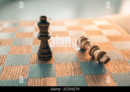 Chess game winning concept. Victory move with last piece standing on chessboard wooden board Stock Photo