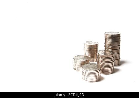 pile of brilliant metallic coins on a white backgr Stock Photo