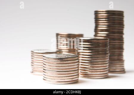 pile of brilliant metallic coins on a white backgr Stock Photo