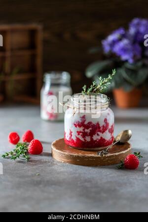 Raspberry smoothie, milkshake in a glass jar on a dark wooden background. Yogurt cocktail. Natural summer detox drink. Healthy eating concept. Stock Photo