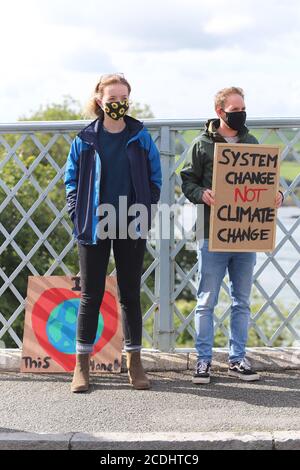 Menai Bridge, Anglesey, 28 August 2020. Extinction Rebellion youth protestors face the bank holiday traffic heading into Anglesey with banners highlighting climate change and calling for action to protect their future Credit: Denise Laura Baker/Alamy Live News Stock Photo