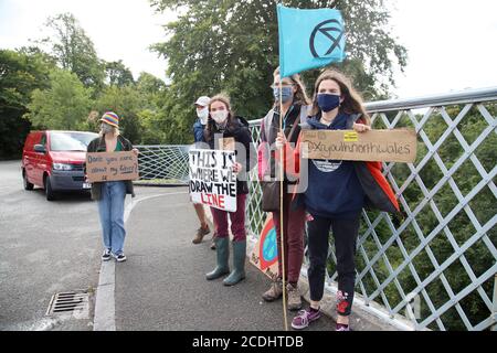 Menai Bridge, Anglesey, 28 August 2020. Extinction Rebellion youth protestors face the bank holiday traffic heading into Anglesey with banners highlighting climate change and calling for action to protect their future Credit: Denise Laura Baker/Alamy Live News Stock Photo