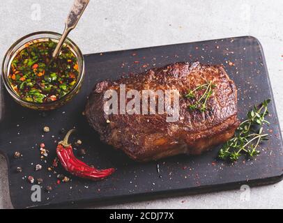 juicy beef steak, mutton roasted on a cutting board, view from above Stock Photo