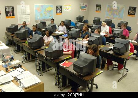 Pine Bluff, AR  October 17, 2006: Community college students learning business administration while working and listening to the instructor in a computer lab. ©Bob Daemmrich Stock Photo