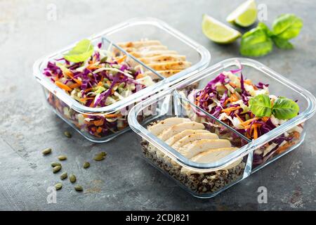 Healthy meal prep containers with quinoa, chicken and Cole slaw Stock Photo