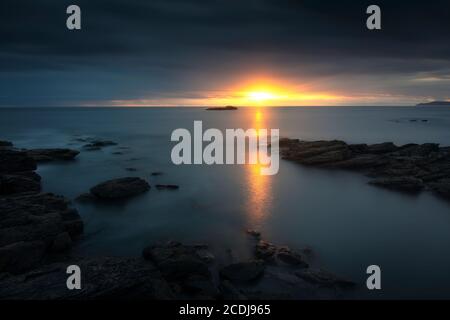 Spectacular sunset with the last rays of the sun over the sea Stock Photo