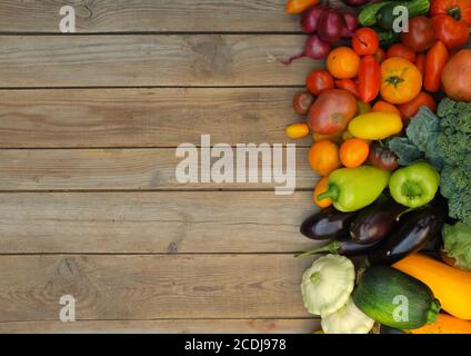 Many different bright, colorful vegetables on a wooden background. Harvest and summer season concept. Stock Photo