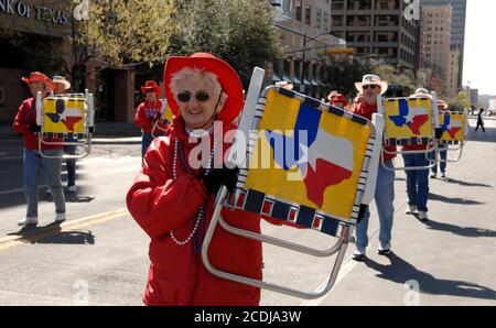 Austin, TX March 3, 2007: A woman in formation shows a Texas flag on a lawn chair as she marches in the Texas Independence Day parade on Congress Avenue celebrating the official March 2nd date of Texas' becoming an independent country following its revolution against Mexican rule. ©Bob Daemmrich Stock Photo