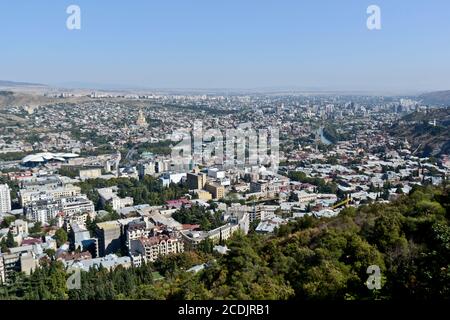 Panoramic view of Tbilisi from Mount Mtatsminda: The Holy Trinity Cathedral of Tbilisi, Kura River, Bridge of Peace. Republic of Georgia Stock Photo