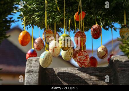Closeup of colorful patterned Easter eggs hanging on the tree Stock Photo