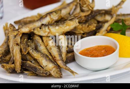 Fried fresh sprat fish with souce. Good seafood.; Stock Photo
