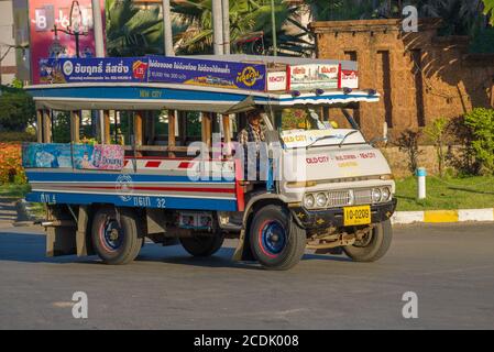 SUKHOTAI, THAILAND - DECEMBER 26, 2018: Shuttle bus (songthaew) at the base of an old Hino truck close up on a sunny morning Stock Photo