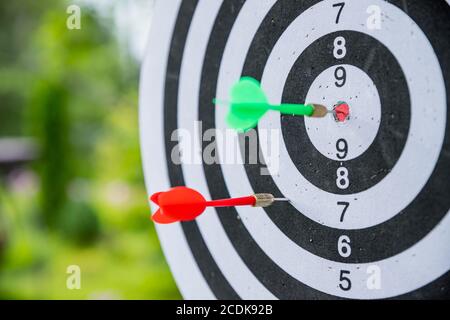 Dartboard with darts. side view of Dartboard with two darts.successful attempt. To attempt difficult task.Dart in bullseye of dartboard concept for Stock Photo