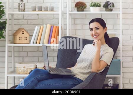 Confident woman working using laptop from home Stock Photo