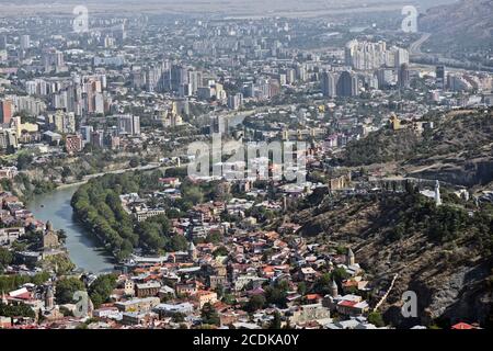 Panoramic view of Tbilisi from Mount Mtatsminda: Sololaki Hill, Kartlis Deda monument, Narikala Fortress and Kura River. Republic of Georgia. Stock Photo